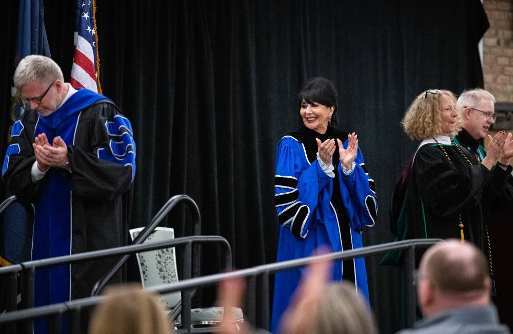 Dean Schaub and President Mantella applaud